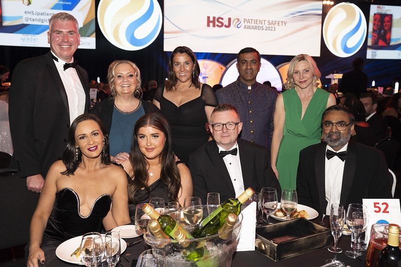 Members of the RAIDR team sat at a table smiling to camera at the HSJ Patient Safety awards 2023