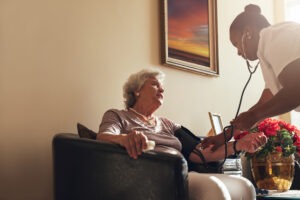 Nurse and elderly patient sitting