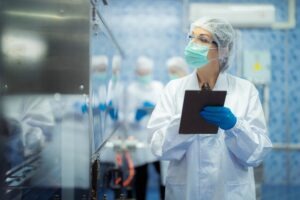 Image of medical worker checking medicines manufacturing