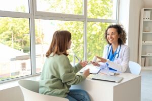 Mature,Female,Doctor,Prescribing,Pills,To,Patient,In,Clinic Doctor prescribing medicines to patient